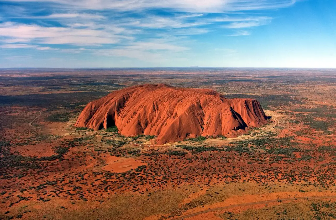 Uluru and the desert seen from a helicopter window