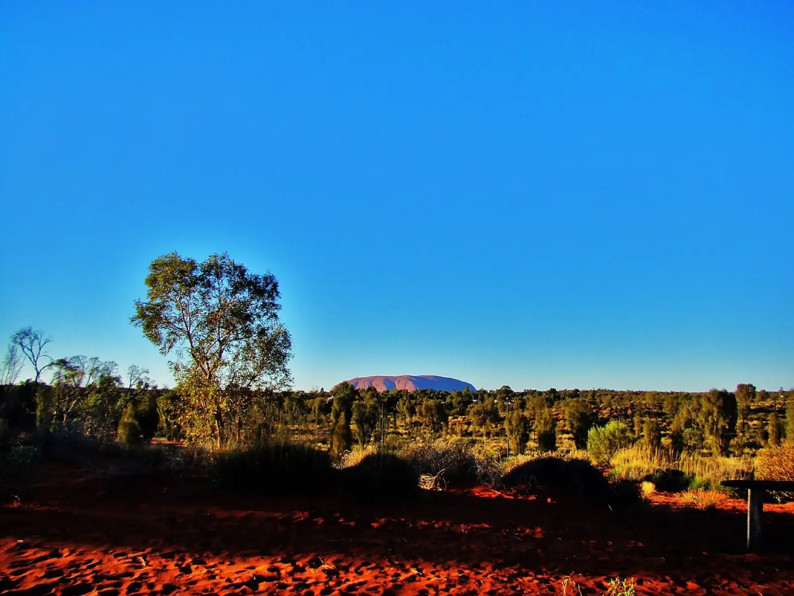 The road into Yulara with Uluru on the horizon